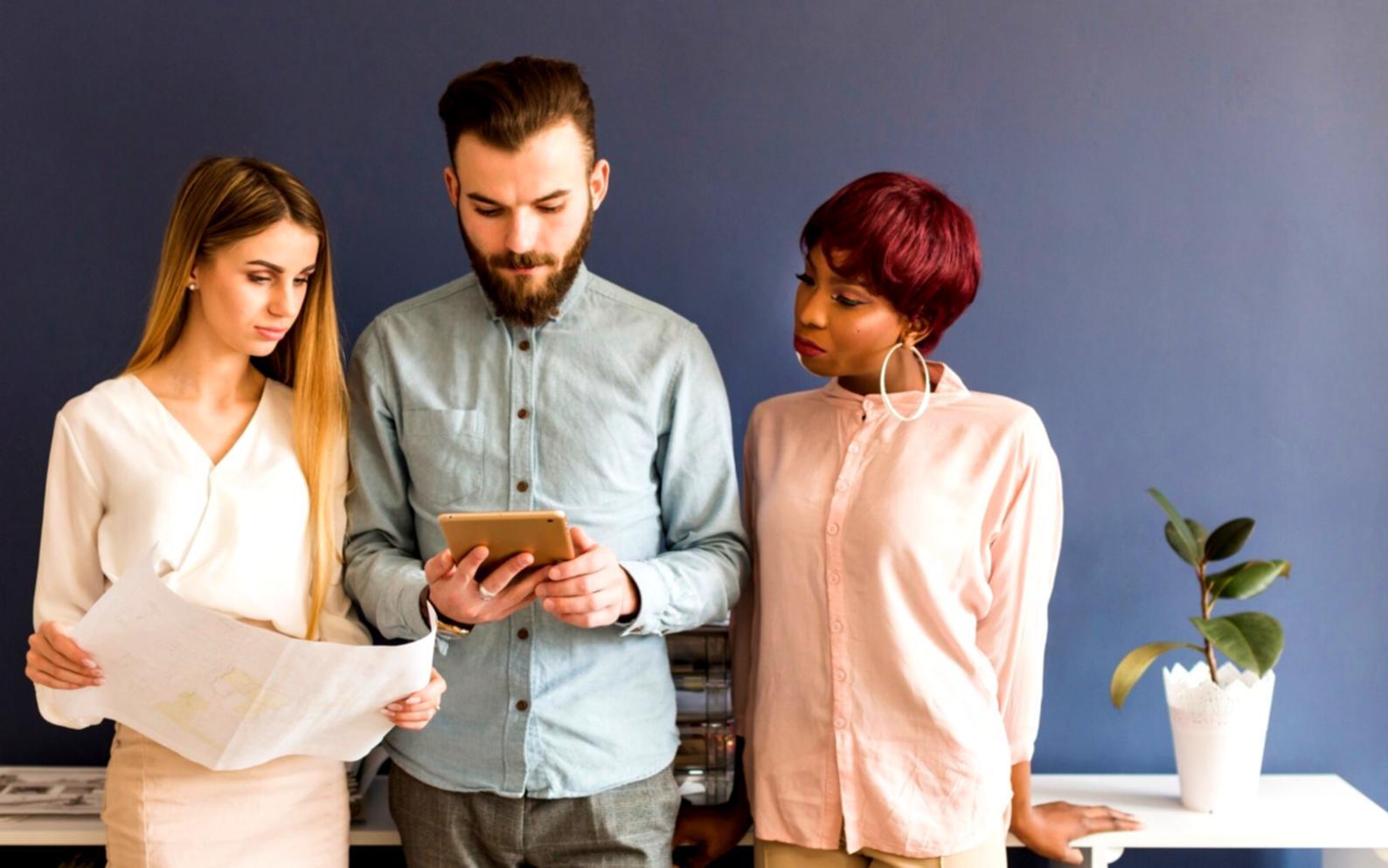 Business team reviewing financial automation workflow on computer screens